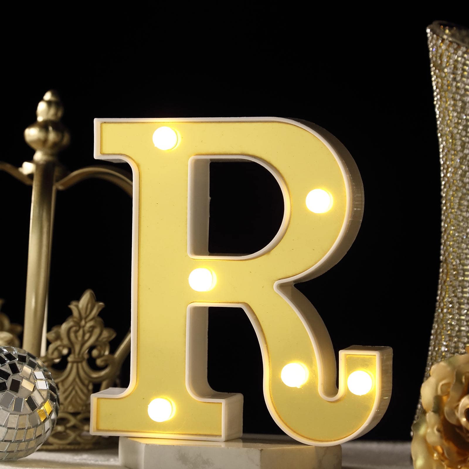 Warm white 3D marquee letter "R" with LED lights.