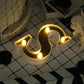 Gold 3D marquee letter "S" with warm white LED lights.