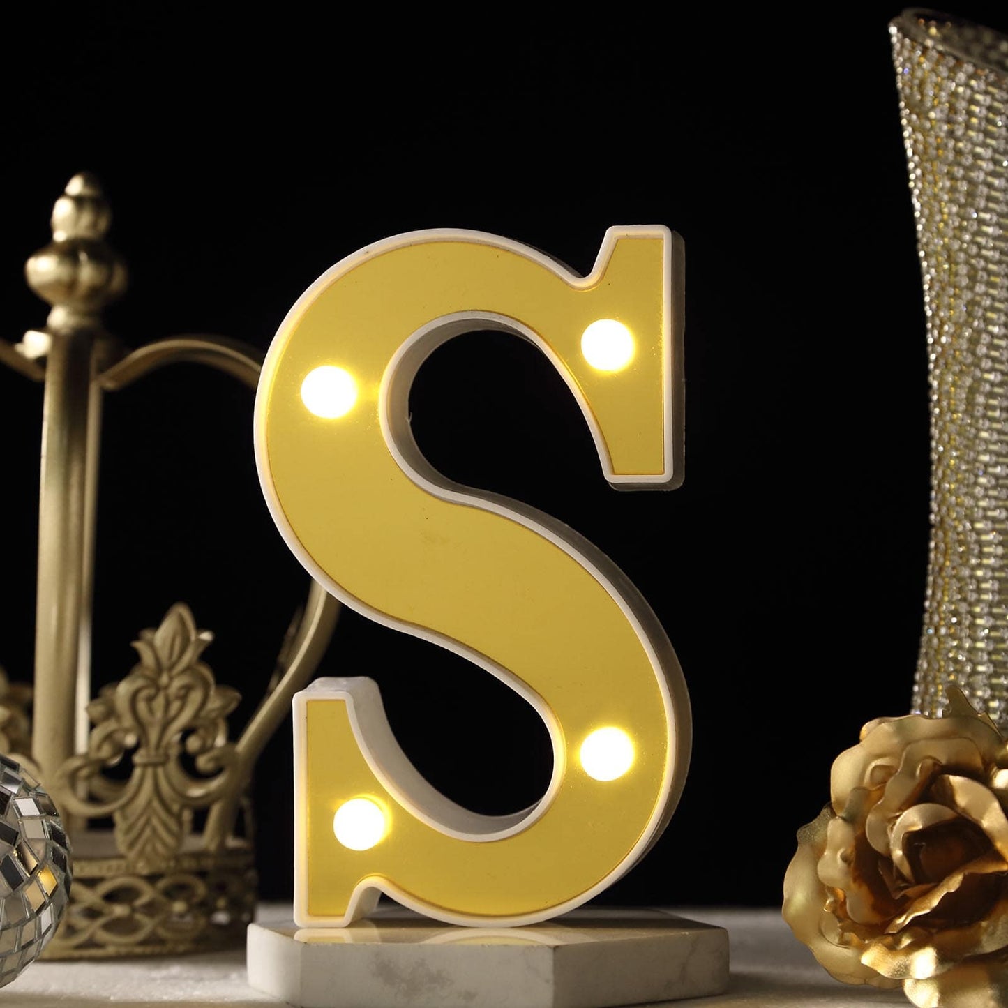 Warm white 3D marquee letter "S" with LED lights.