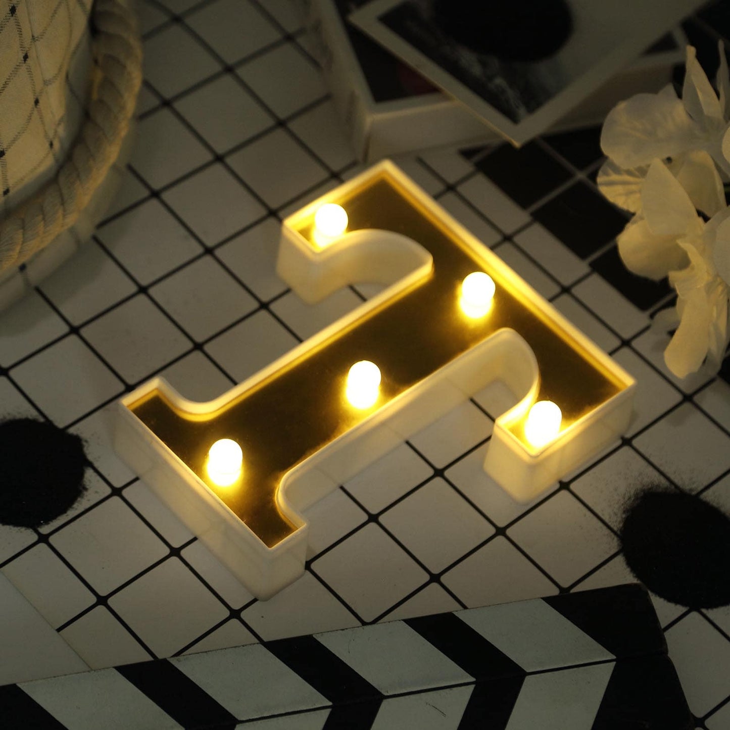 Gold 3D marquee letter "T" with warm white LED lights.