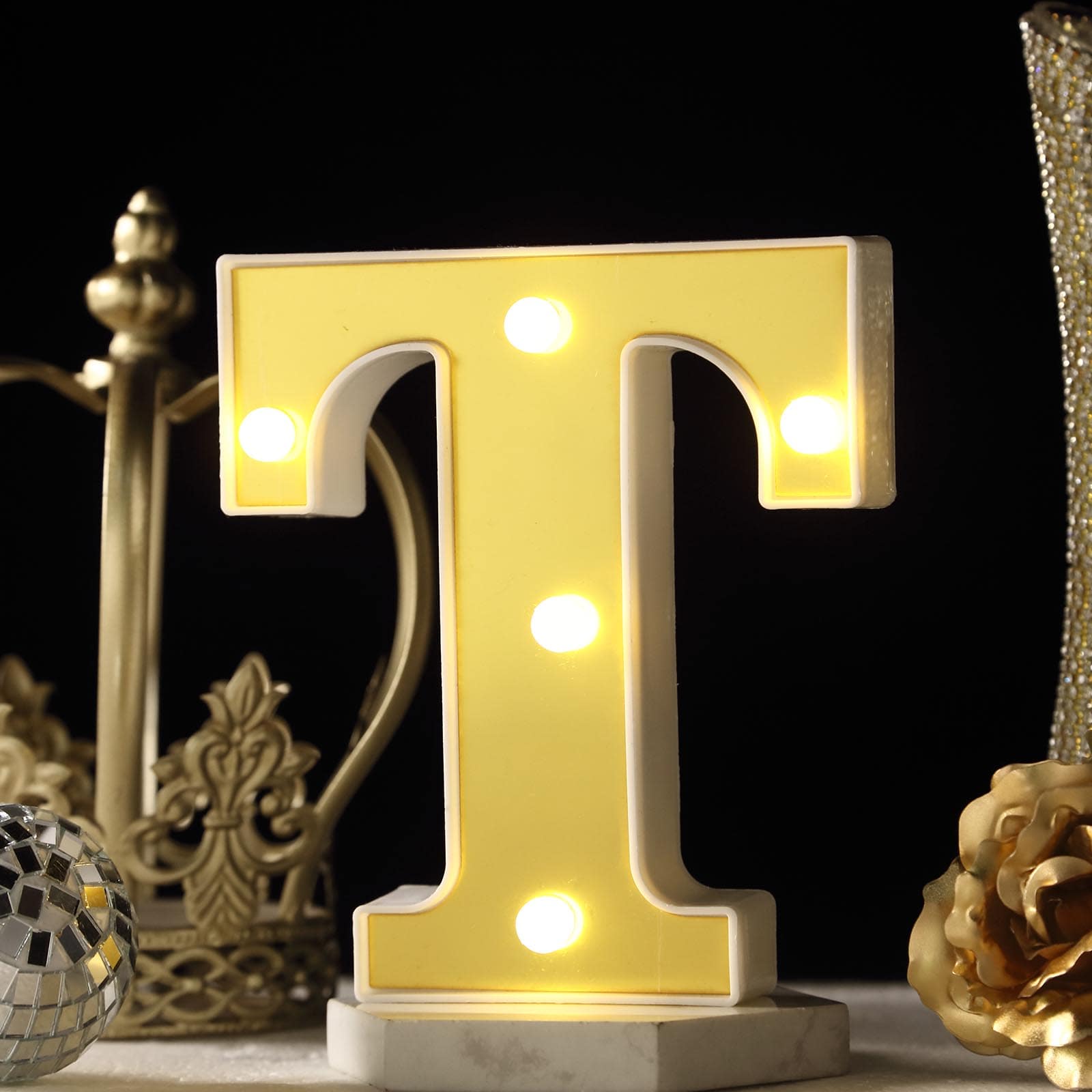 Warm white 3D marquee letter "T" with LED lights.