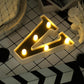 Gold 3D marquee letter "V" with warm white LED lights.