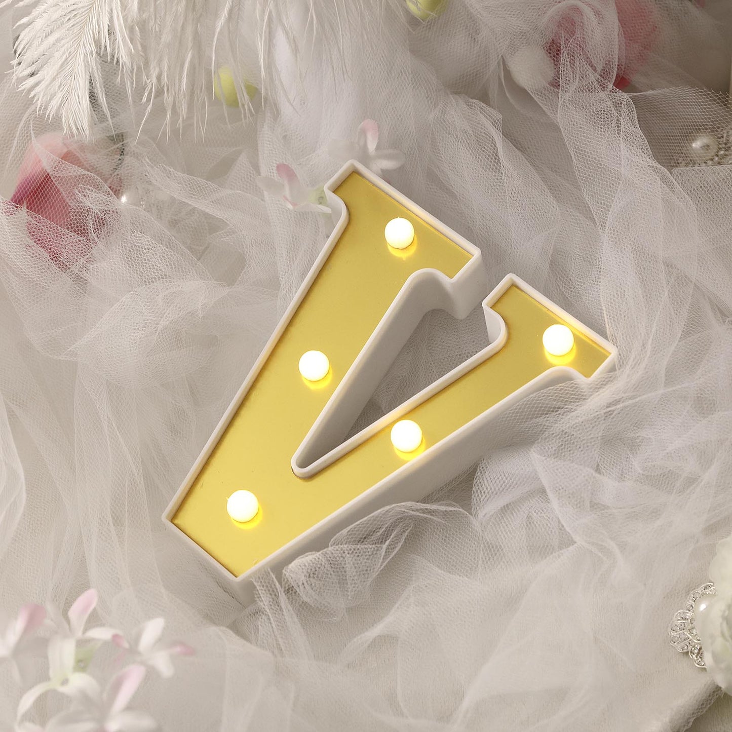 Warm white 3D marquee letter "V" with LED lights.