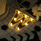 Gold 3D marquee letter "W" with warm white LED lights.