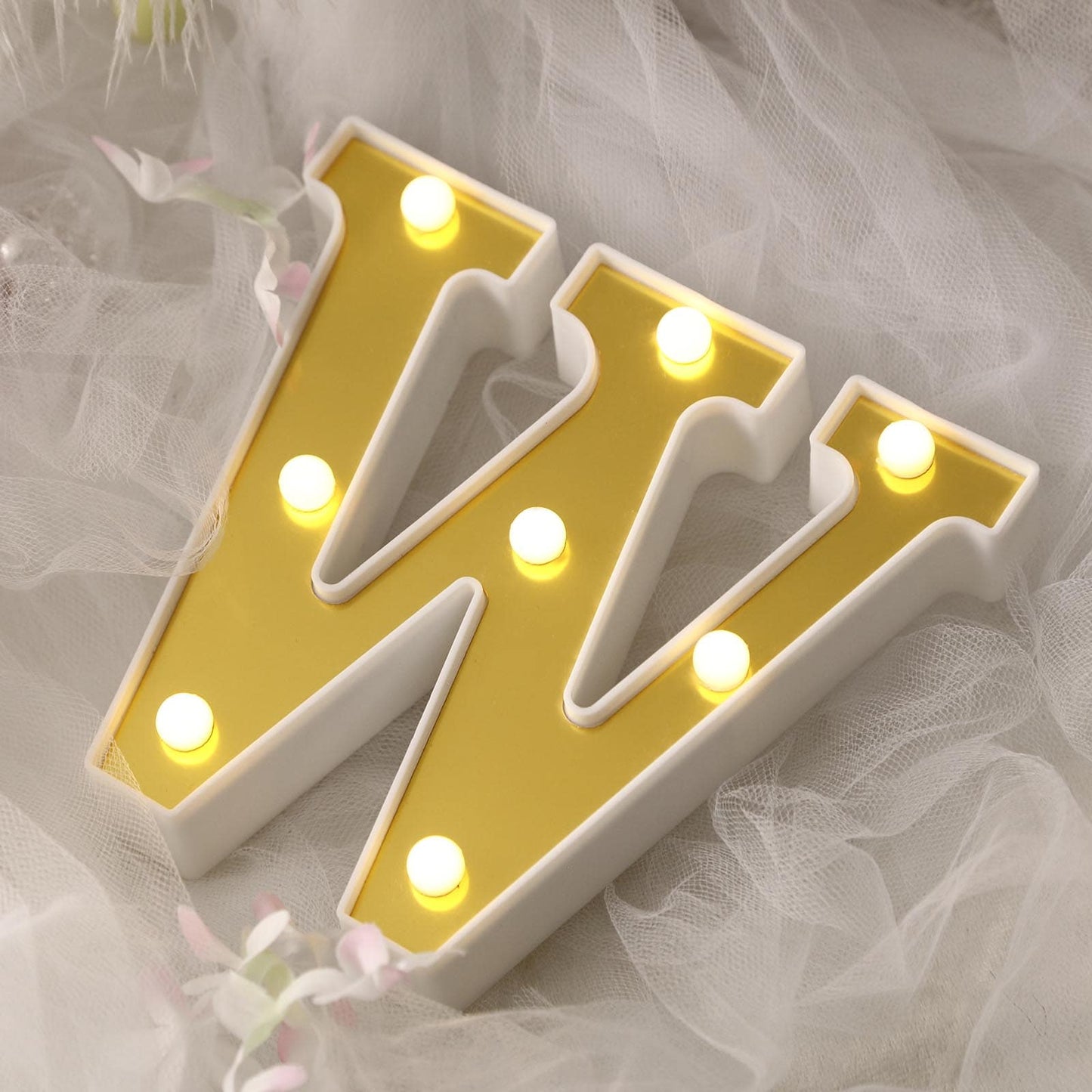 Gold 3D marquee letter "W" with warm white LED lights.