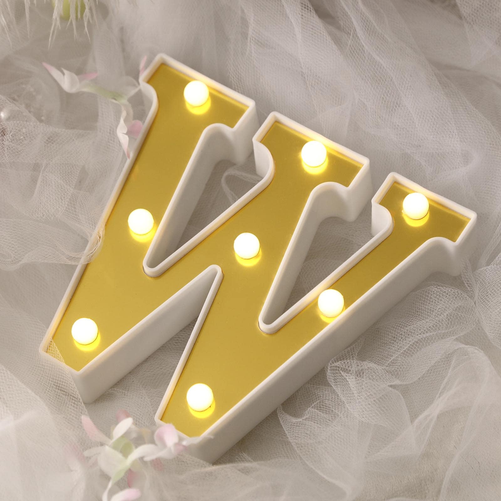 Gold 3D marquee letter "W" with warm white LED lights.