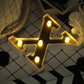 Gold 3D marquee letter "X" with warm white LED lights.