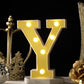 Gold 3D marquee letter "Y" with warm white LED lights.