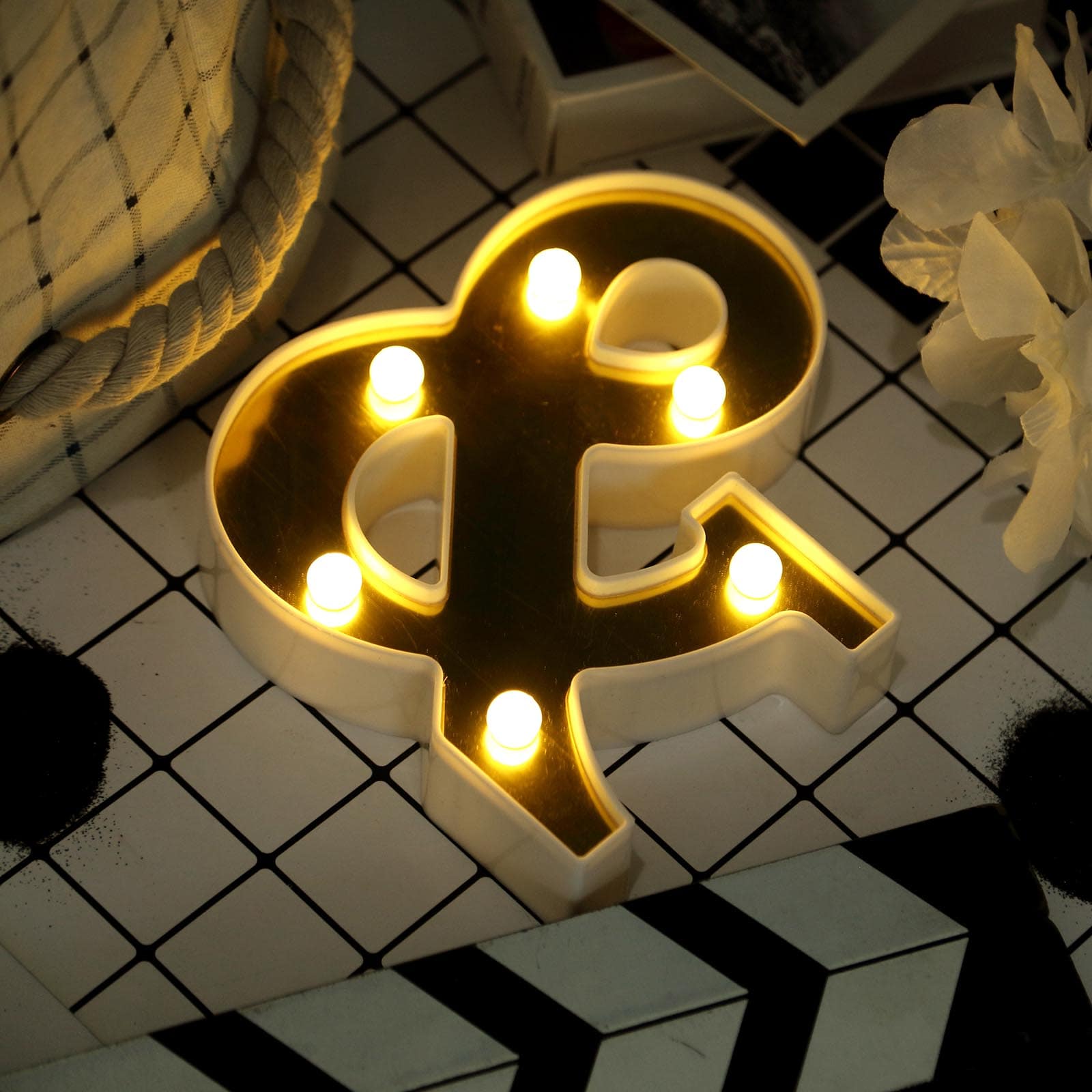 Gold 3D marquee ampersand symbol with warm white LED lights.