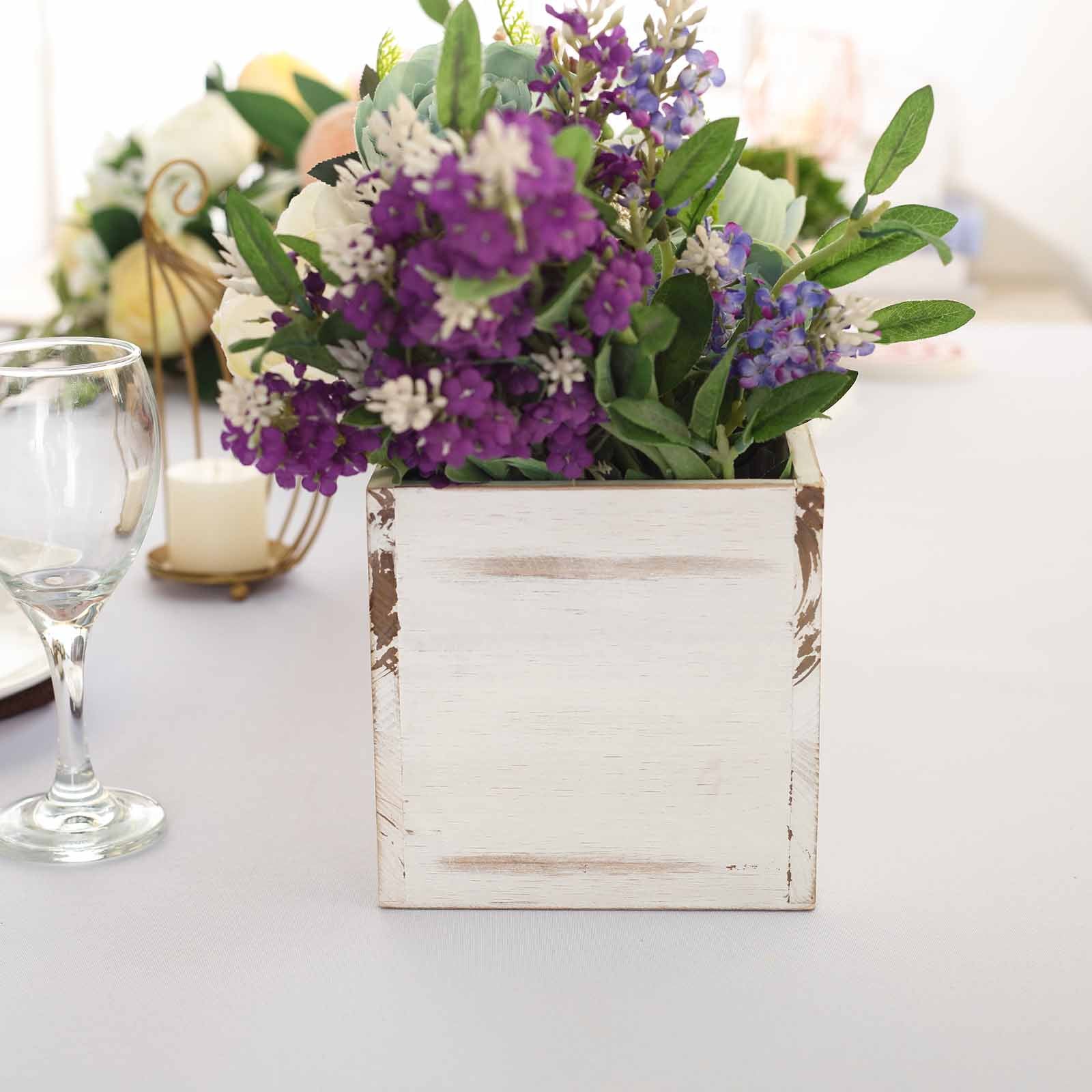 Whitewash rectangular wood planter box with plastic liner and flowers.