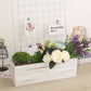 Whitewash rectangular wood planter box with flowers and greenery.
