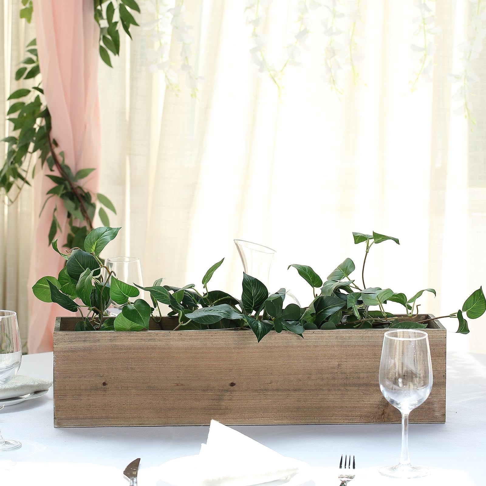 Natural rectangular wood planter box with removable plastic liners and greenery.