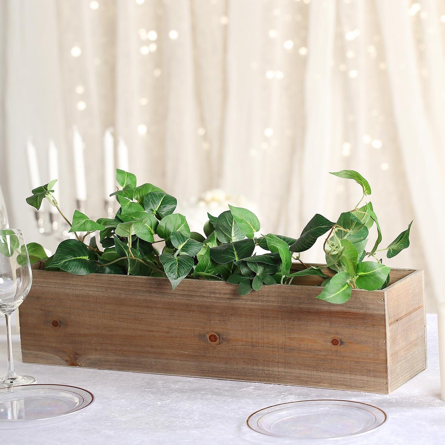 Natural wood planter box with removable plastic liners and greenery.