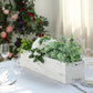 White rectangular wood planter box with removable liners, filled with greenery and flowers.
