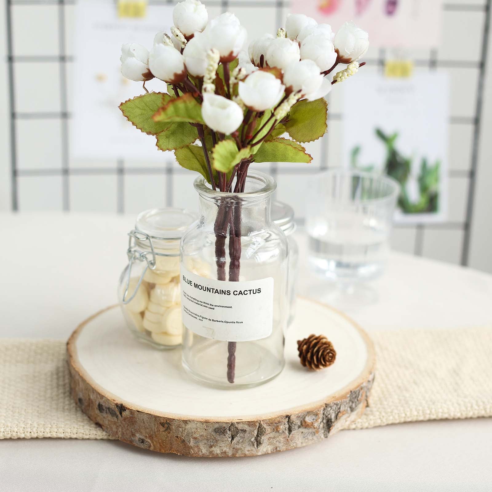 Rustic natural wood slice table centerpiece with flowers.