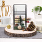 Natural wood slice centerpiece with rustic decor and greenery.