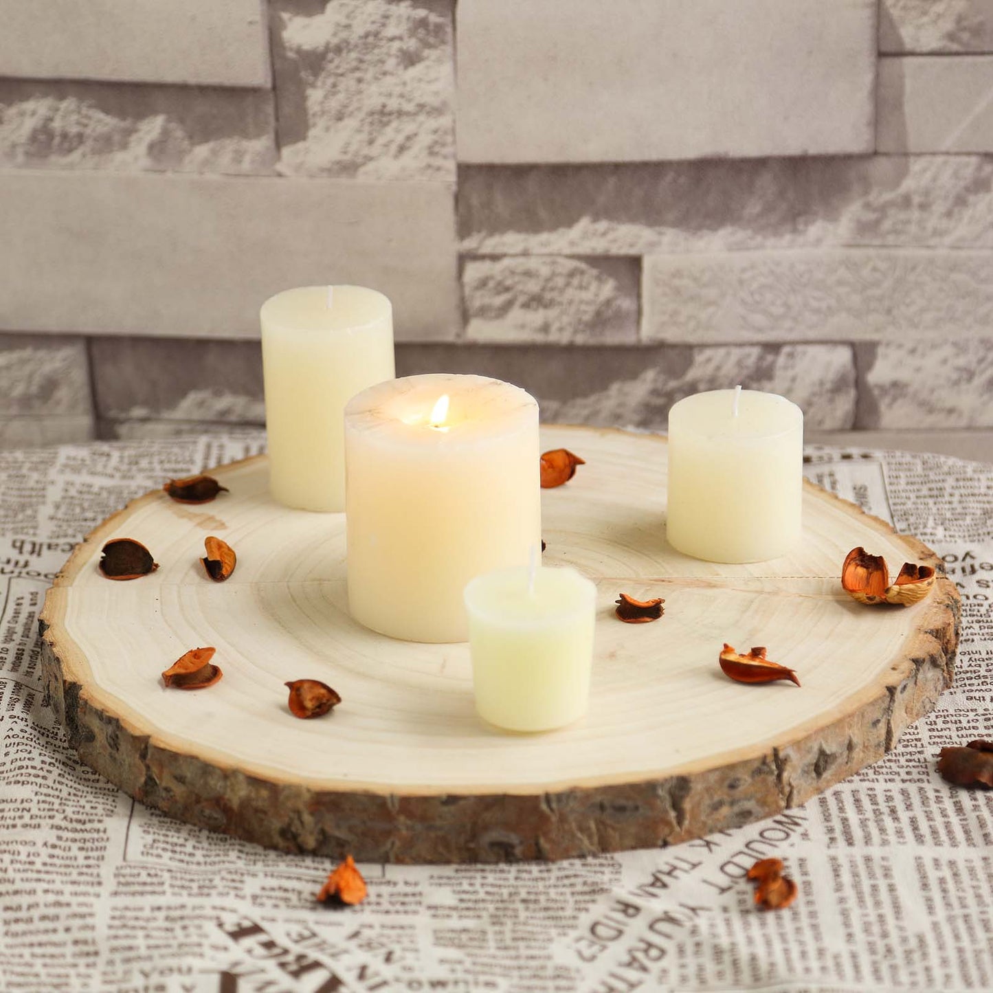Natural color round rustic wood slice with candles and petals.