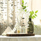 Round rustic wood slice centerpiece with natural wood finish and decorative vases.