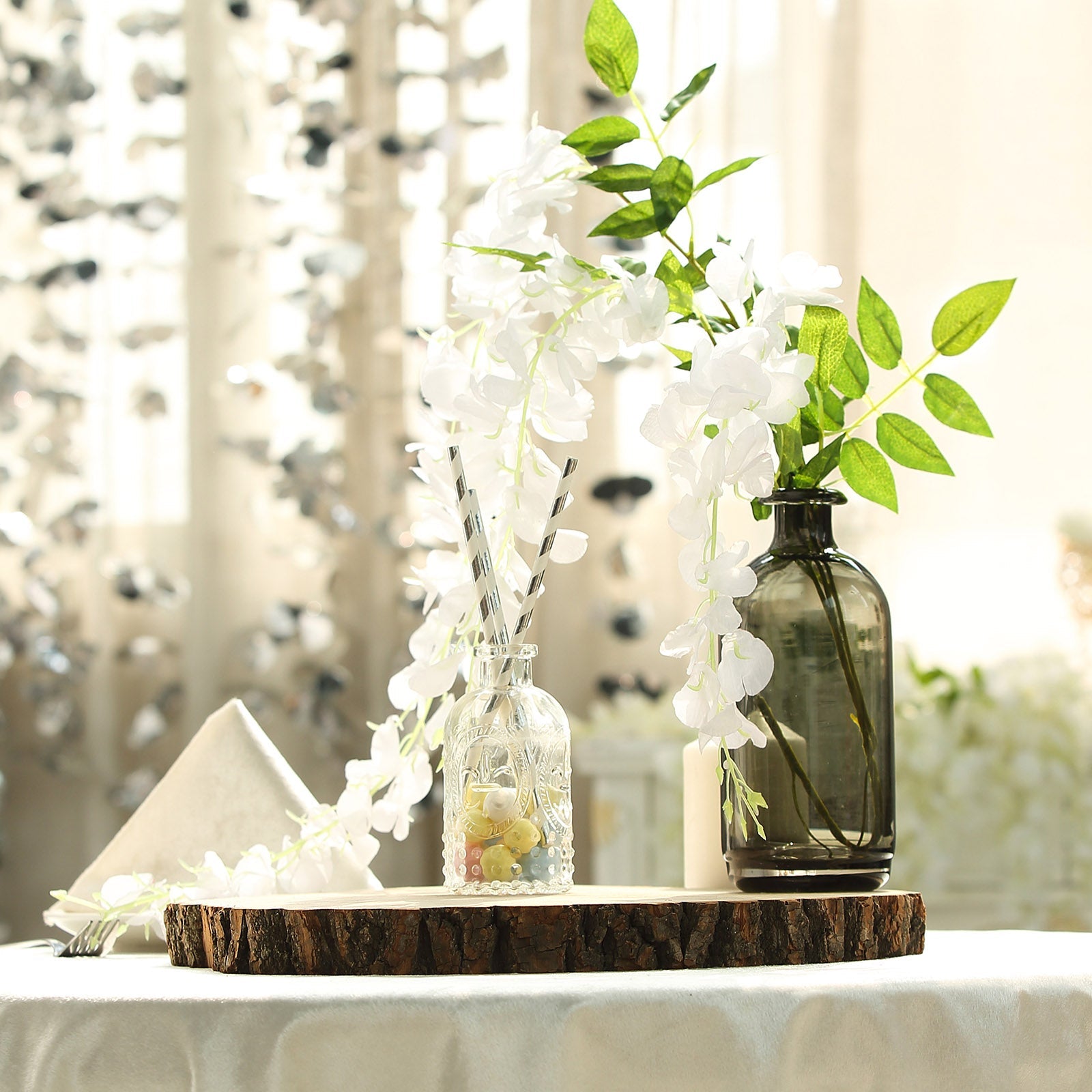 Round rustic wood slice centerpiece with natural wood finish and decorative vases.
